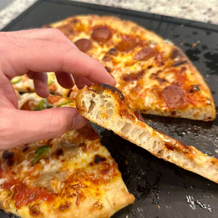 Side view of slice pizza with airy crust