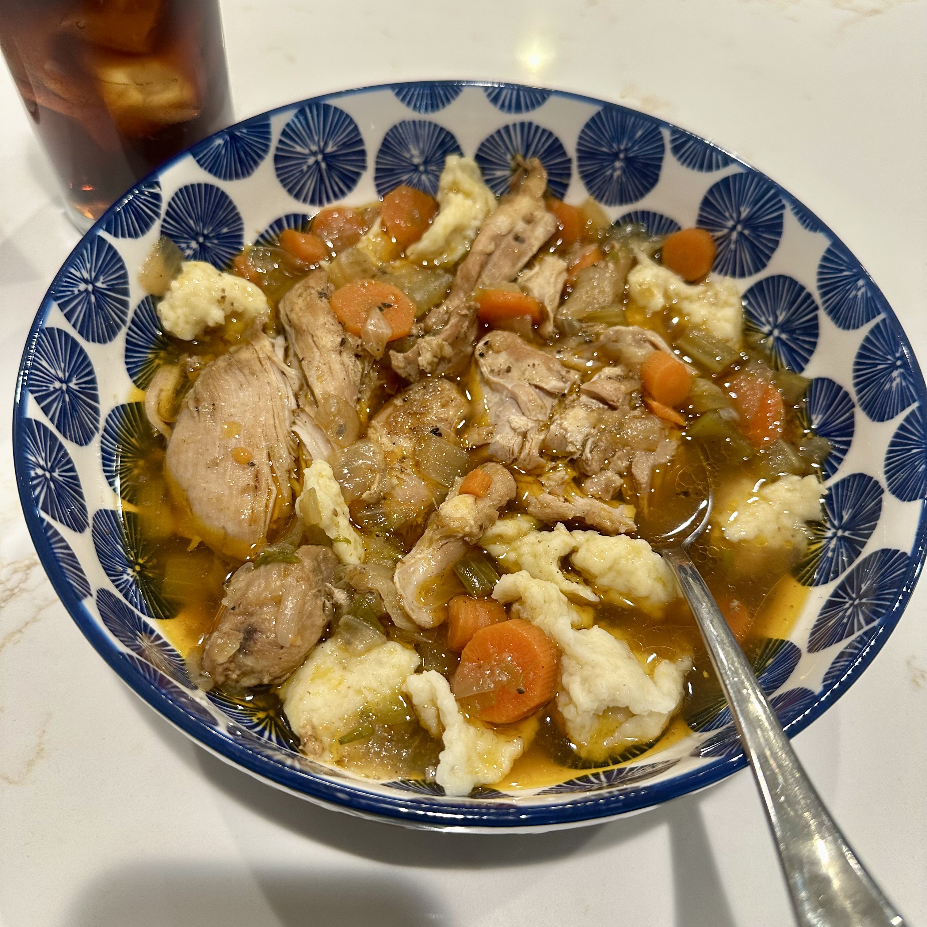 A bowl of homemade chicken stew and dumplings cooked by my dad